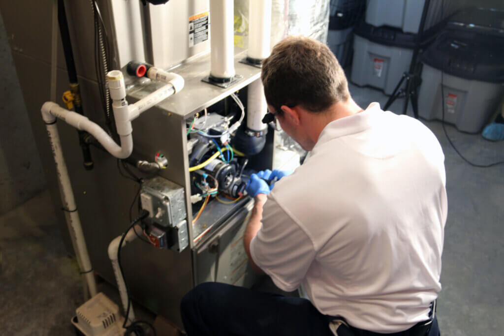 HVAC technician replacing a furnace